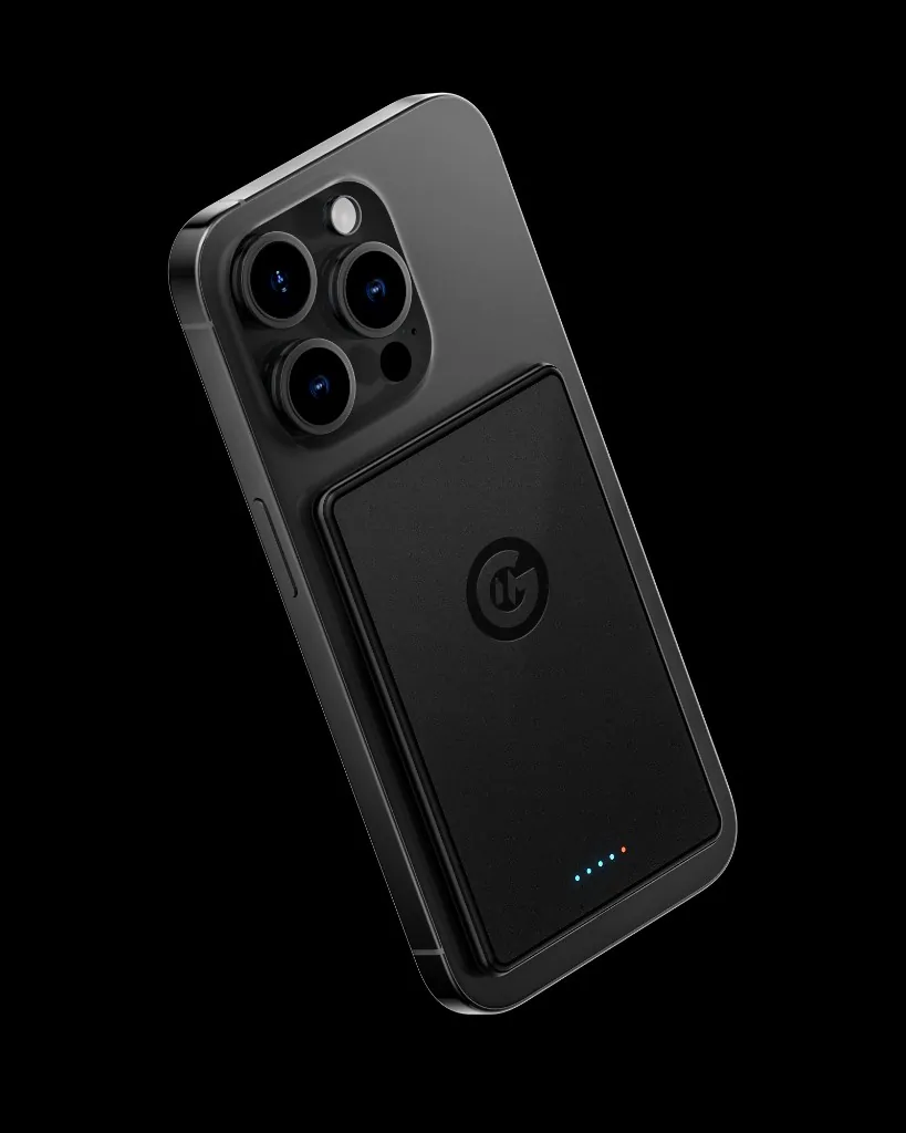 MagFusion Air magnetic power bank attached to the back of a phone, with its charge indicator lights on